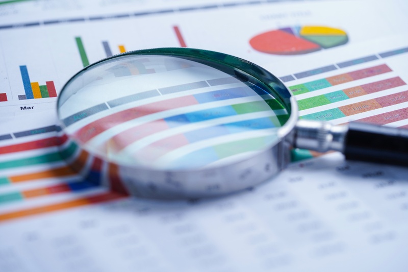 Dokument mit Businessdaten und einer Lupe